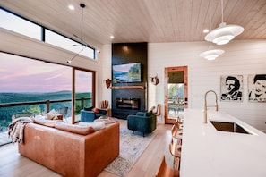 Luxury amenities, a large chef's kitchen and modern Scandinavian design complement stunning wall-to-wall mountain views.