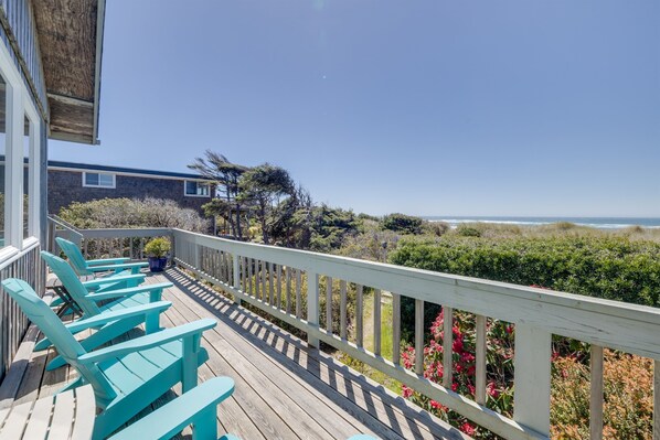 Relaxing on your private deck, enjoying the sounds of the waves