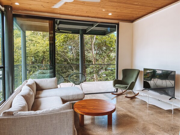 The comfortable living room features a SMART TV and large terrace.