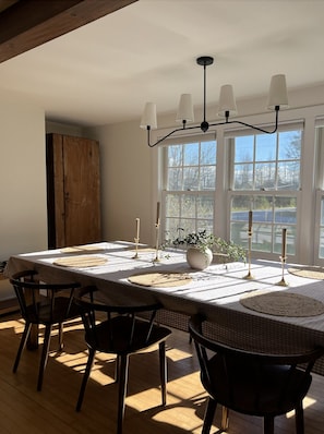 Open kitchen and dining area with a large dining table that seats up to 8-10. 