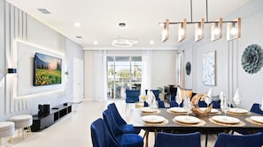 Bright and chic living space with elegant dining, plush seating, and patio views.