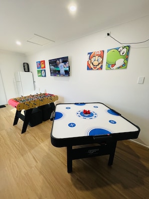 4-player air hockey or foosball. BYO bragging rights. Spare fridge if required