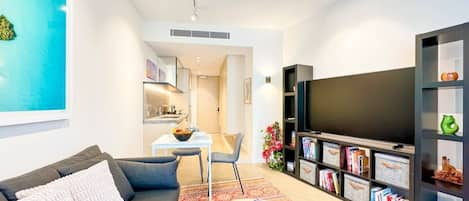 living area with smart TV and book case