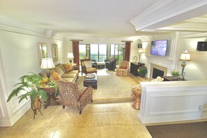 Relax in the main great room, with comfortable seating and gorgeous waterfront views.