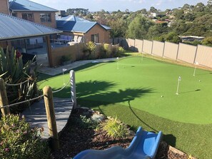 Backyard; slide, tramp, swing, putting green, pool and spa