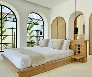 Master bedroom with a king-size bed, working area, large closets, and an ensuite bathroom