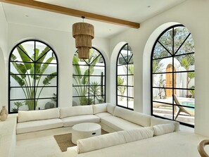 White sunken lounge with a pool view