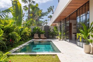 Two daybeds near the swimming pool