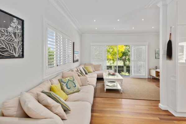 The spacious living area flows through to the front deck, creating a seamless transition between the indoors and out.