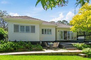 This house is nestled among gorgeous gardens with a mix of tasteful indoor and outdoor spaces.