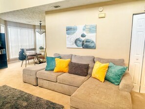 Family Room with Smart TV, Books, Toys, and High Chair tucked away.