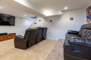 Watch a movie in the lower level den or play games on the other side of the room.