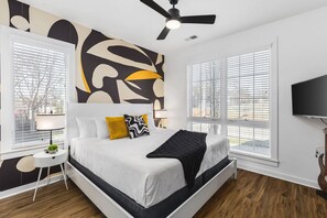 Bedroom #1 on the ground floor with a king bed, ceiling fan, Smart TV, and ensuite bathroom.