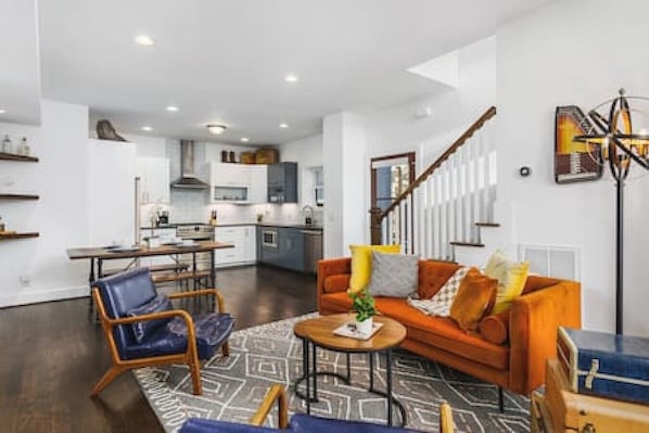 Cozy living room with a Smart TV, big windows, and thoughtful decor.