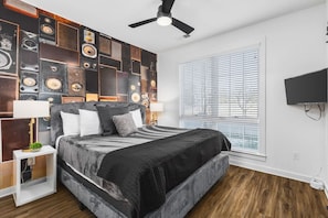 Bedroom #1 on the ground floor with a king bed, ceiling fan, Smart TV, and ensuite bathroom.