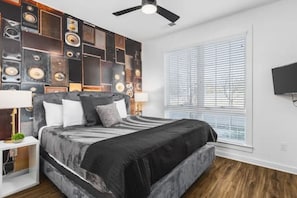 Bedroom #1 on the ground floor with a king bed, ceiling fan, Smart TV, and ensuite bathroom.