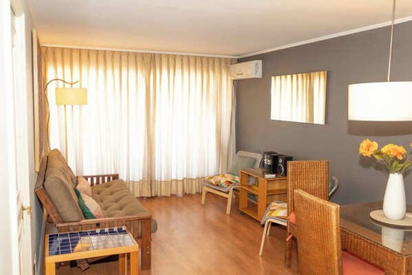 Cozy living area with natural light, perfect for relaxing after exploring the city. Enjoy a coffee with views from the comfort of your studio.