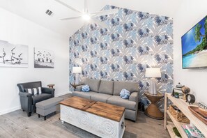 Newly updated living area with queen size sleeper sofa, new accent chair and flat screen TV
