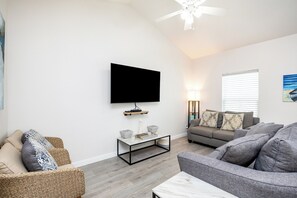 Relax in the modern living room equipped with a  sleek flat-screen TV