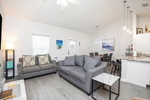 Spacious open-concept design featuring a gourmet kitchen, elegant dining area, and a comfy living room
