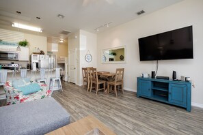 Living room area with natural lighting and flat screen TV