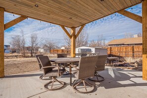 Large backyard with patio seating and grill