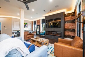 [Fireplace] Cozy Living Room with a Gas Fireplace and an Abundance of Lighting