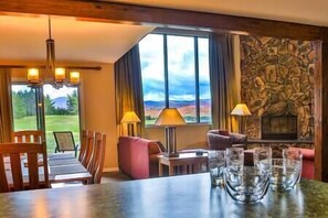View of sentinel mountain range from living room, ding room and kitchen