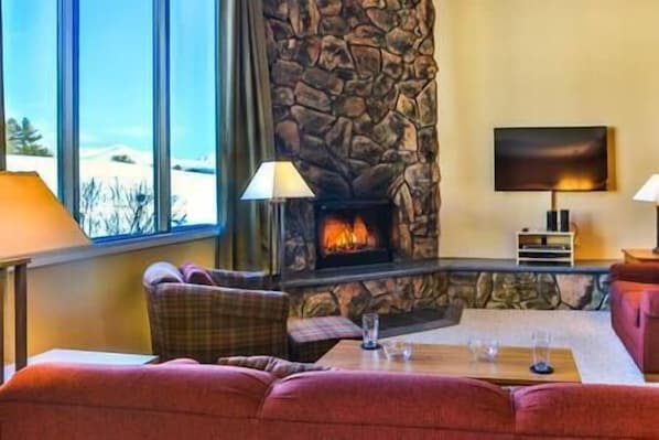Enjoy a warm wood burning fire and the views from the Living Room