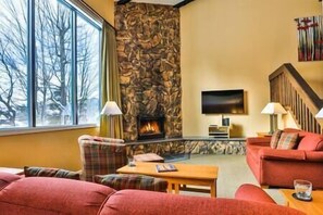 Enjoy a warm woodburning fire and the views from the Living room