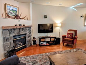 Relax by the cozy gas fireplace and watch the game on the flat screen TV