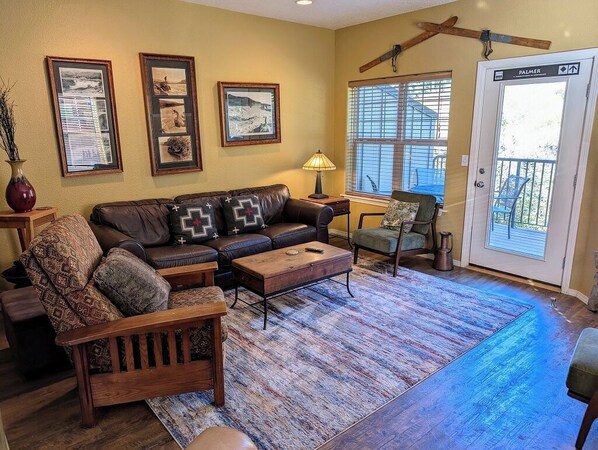 Cozy living room area with couch, recliner, and two lounge chairs.