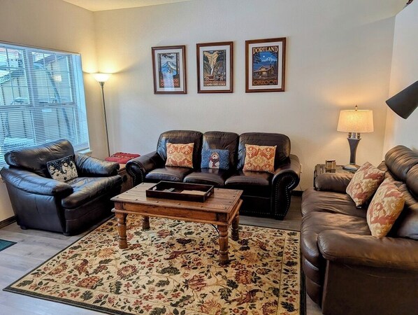 Relax on the couches by the fireplace in the main living room area