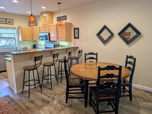 Dining table and breakfast bar. Two extra dining chairs are available in the home