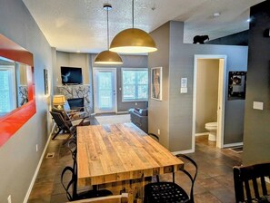 Looking out into the second floor from the kitchen area. Entry to the half bathroom is visible.