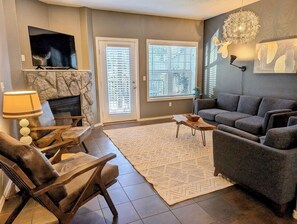 Gas fireplace, Smart TV, and reading chairs in the living room