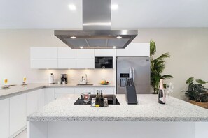 Elevate your culinary experience in our fully equipped kitchen, showcasing cutting-edge stainless-steel cooking appliances and contemporary conveniences for a chef's dream come true.