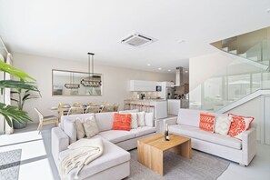 Cozy evenings await in our living area adorned with comfortable sofas and plush pillows, where you can stream your favorites on the Smart TV with Amazon Prime Video and Netflix.