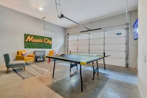 Discover your game room oasis in Nashville! Perfect for gatherings, this stylish space features a ping pong table and cozy seating for fun and laughter after city explorations. Make unforgettable Music City memories!