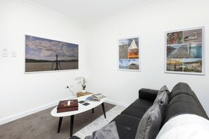 This inviting living space is designed for relaxation and entertainment, with comfortable seating and stylish artwork.