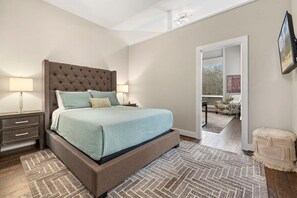 The primary suite features a queen bed, smart tv, large walkin closet, and an attached bathroom.