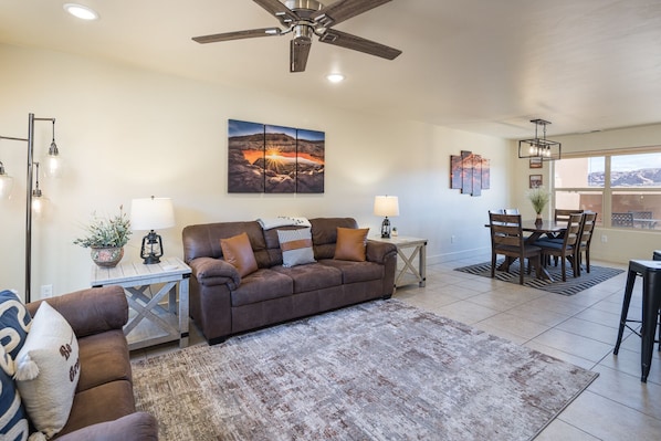 living room with cozy furnishings, queen sofa bed and large tv