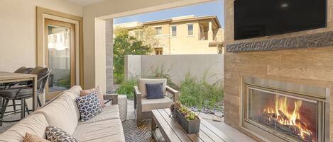 Enjoy your evenings on the back patio with outdoor seating, TV, and fireplace
