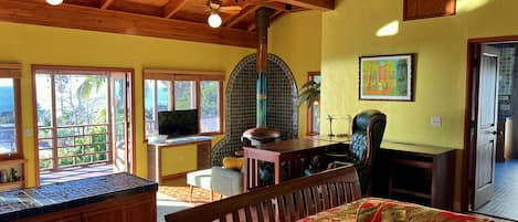 Large studio with a free-standing copper fireplace in the sitting area.