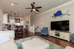 Open concept living, dining, and kitchen area on the third floor