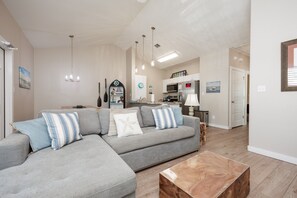 Open-concept living space featuring contemporary furnishings and bathed in natural light