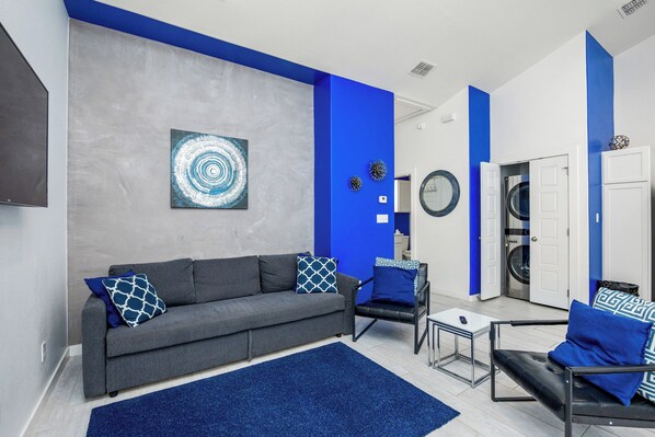 This vibrant living area with modern furniture is the perfect place to relax after a day in the sun