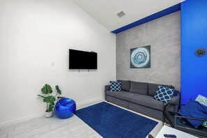 Living area with queen size sleeper sofa, modern furniture, and flat screen TV