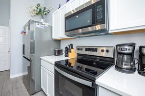 Fully equipped kitchen area with coffee maker