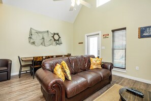 Bright living area with queen size sofa sleeper and  plenty of seating for your shipmates
